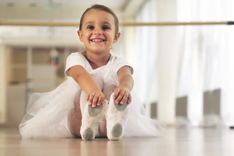 Kleine Kinder in rosa Trikots im Ballettsaal